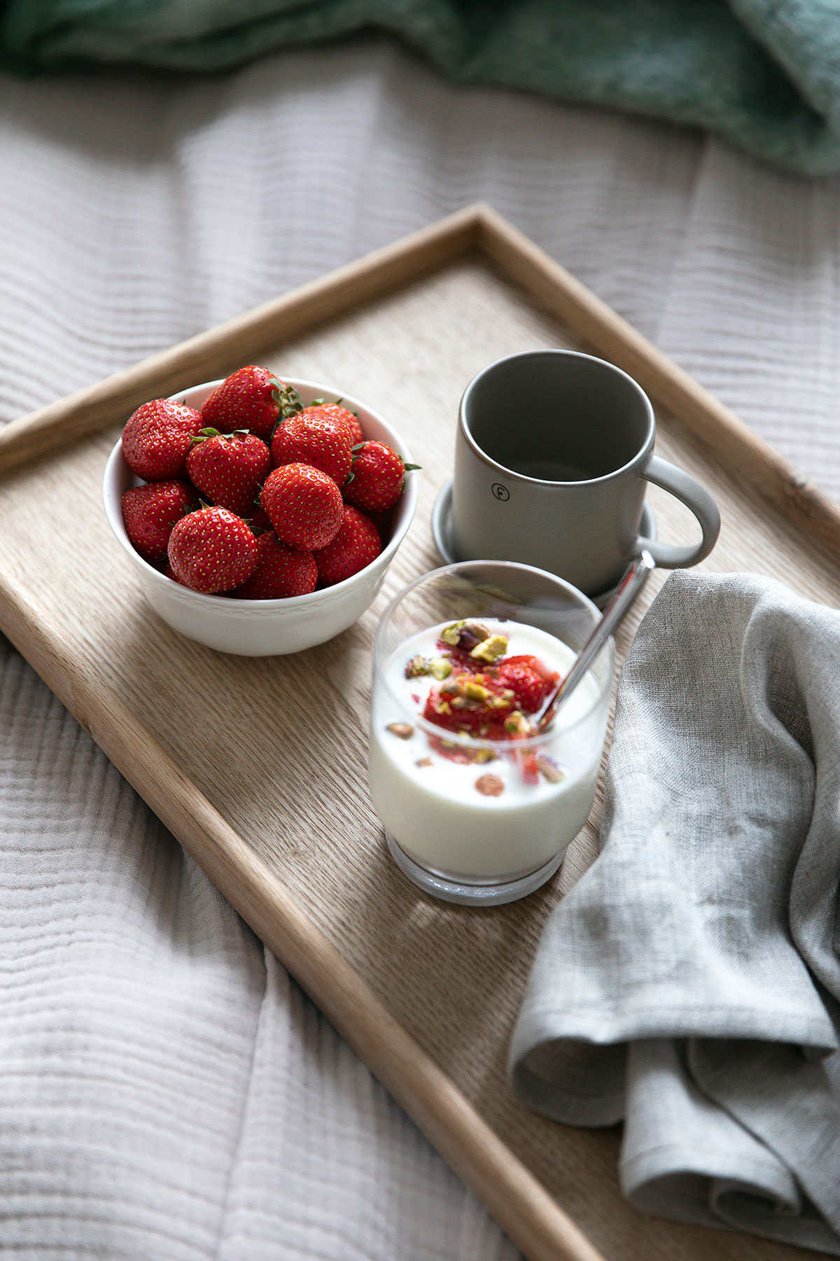 a tray with strawberries and a cup of milk
