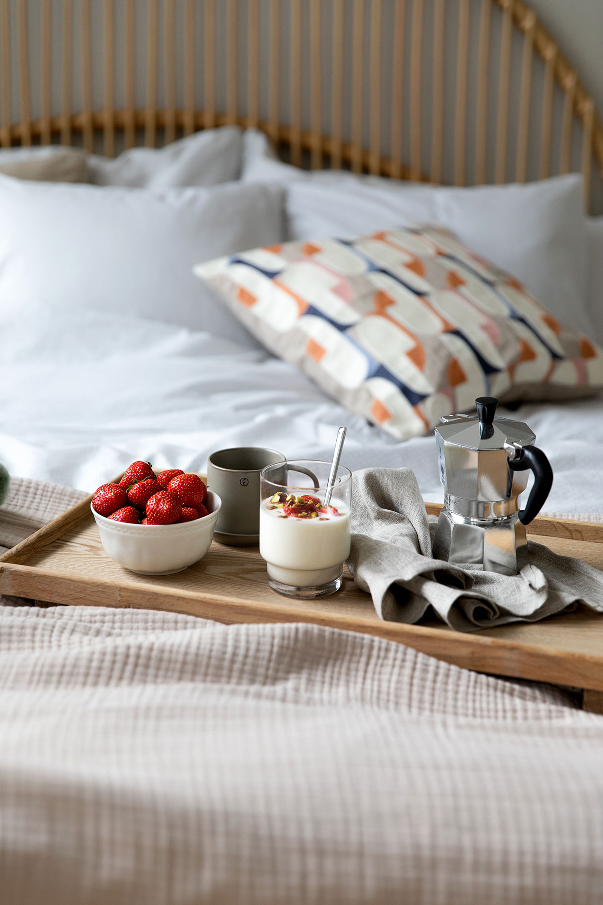 a tray of food on a bed