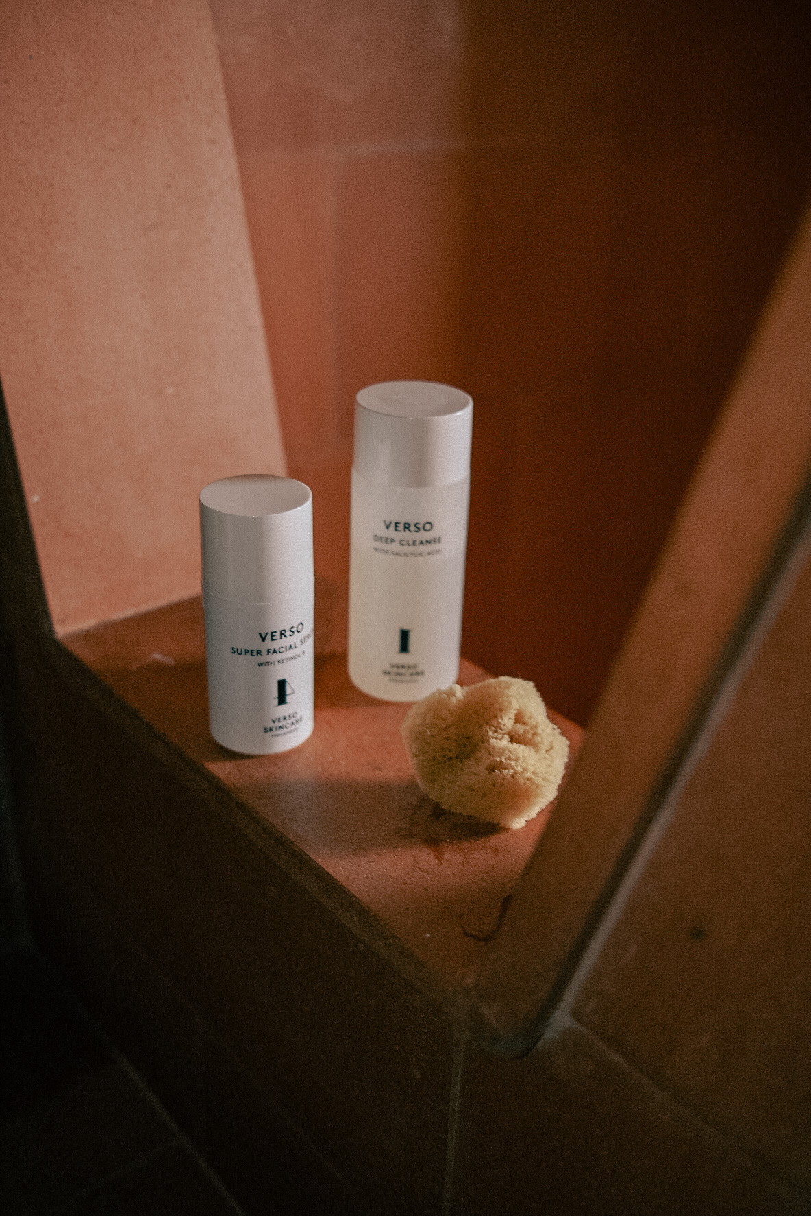 a group of white bottles next to a sponge