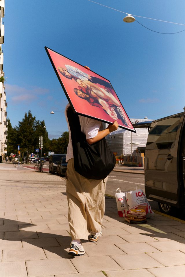a person holding a large poster over their head