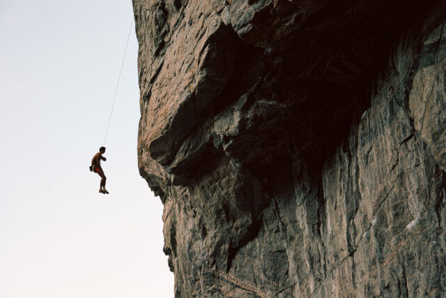 a person from a rope on a cliff