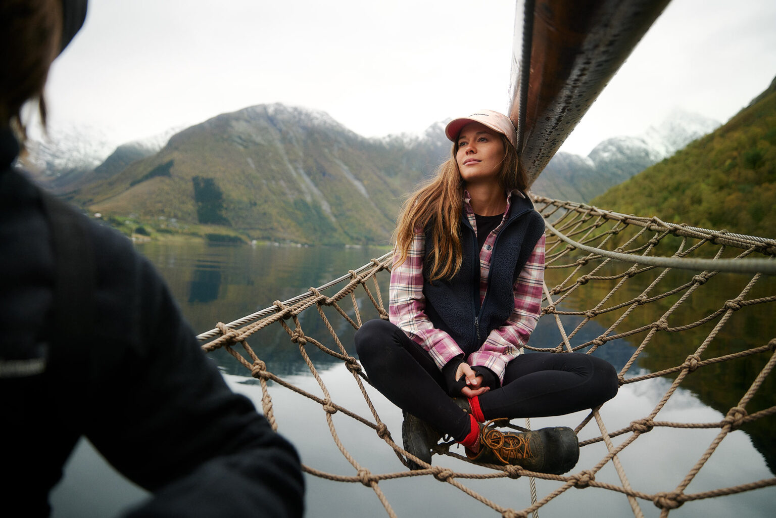 a woman sitting on a hammock