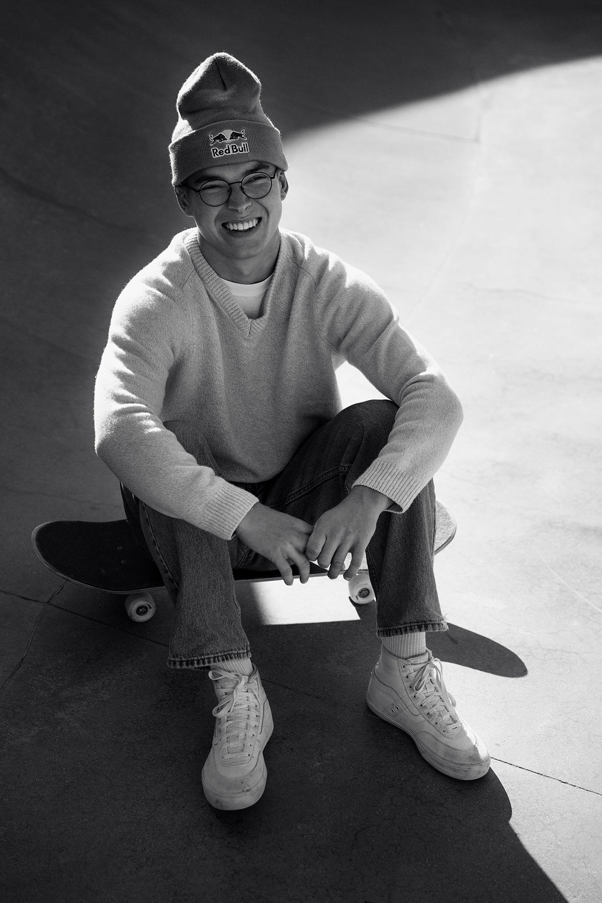 a man sitting on a skateboard
