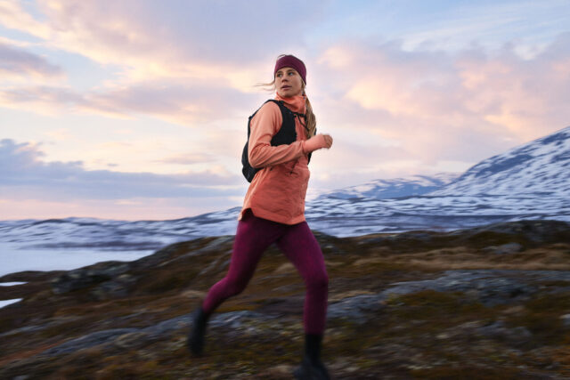 a woman running on a rocky terrain