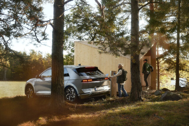 a man standing next to a car