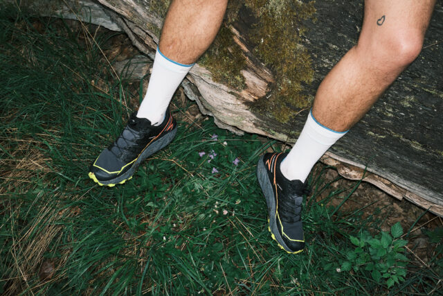 a person's legs and feet in the grass