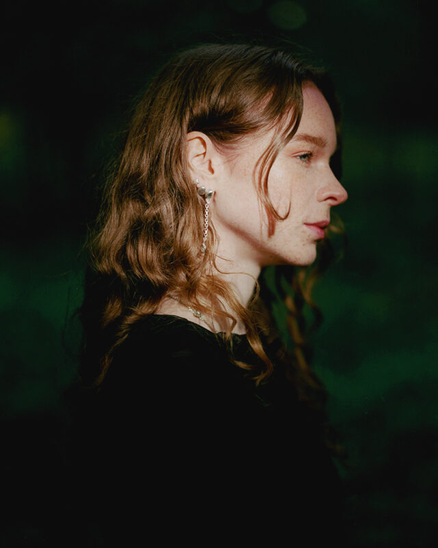 a woman with long hair wearing a black shirt