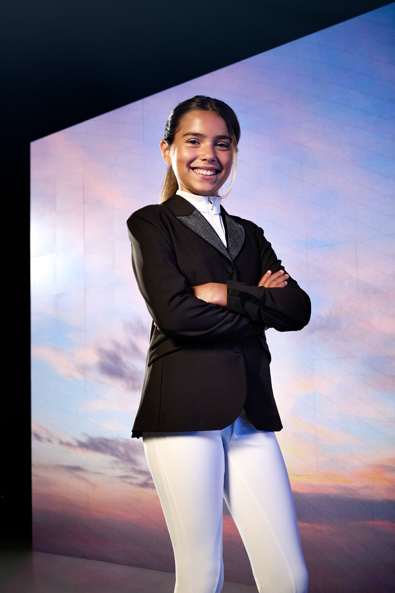 a woman in a suit with her arms crossed