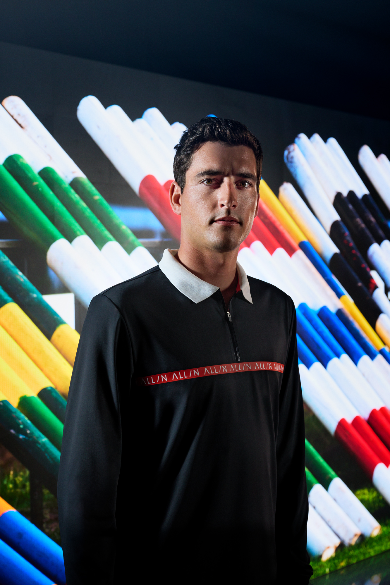 a man standing in front of a colorful background