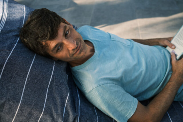 a man lying on a pillow