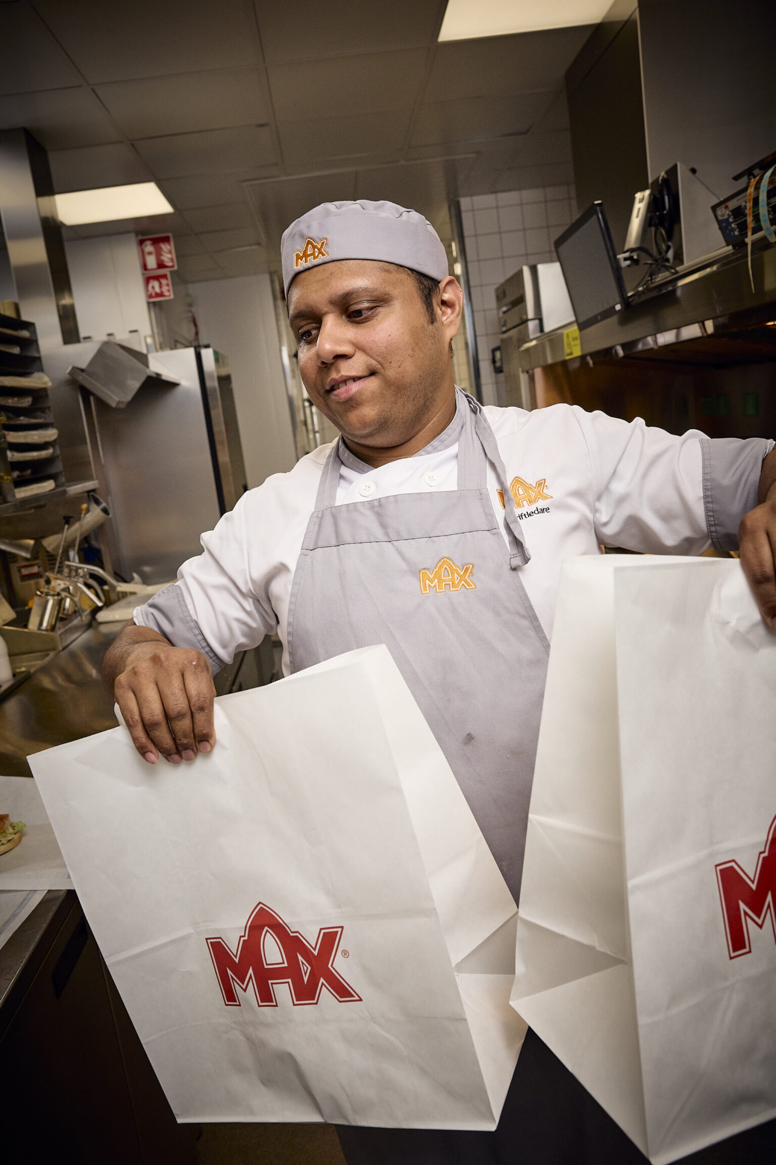 a man holding two white bags