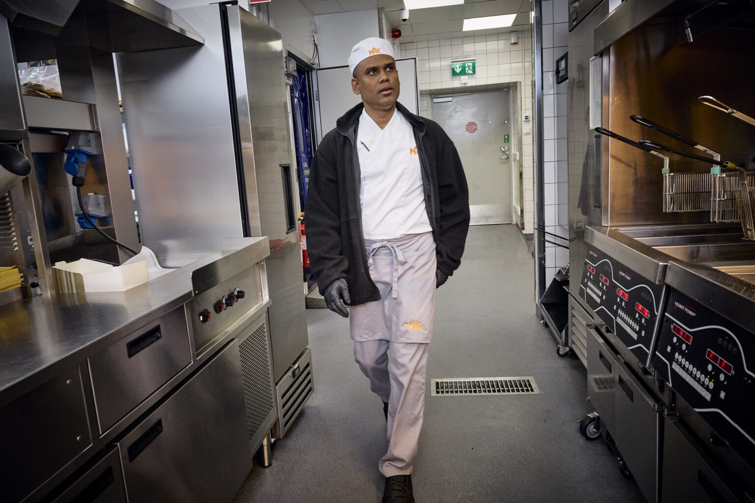 a man walking in a kitchen