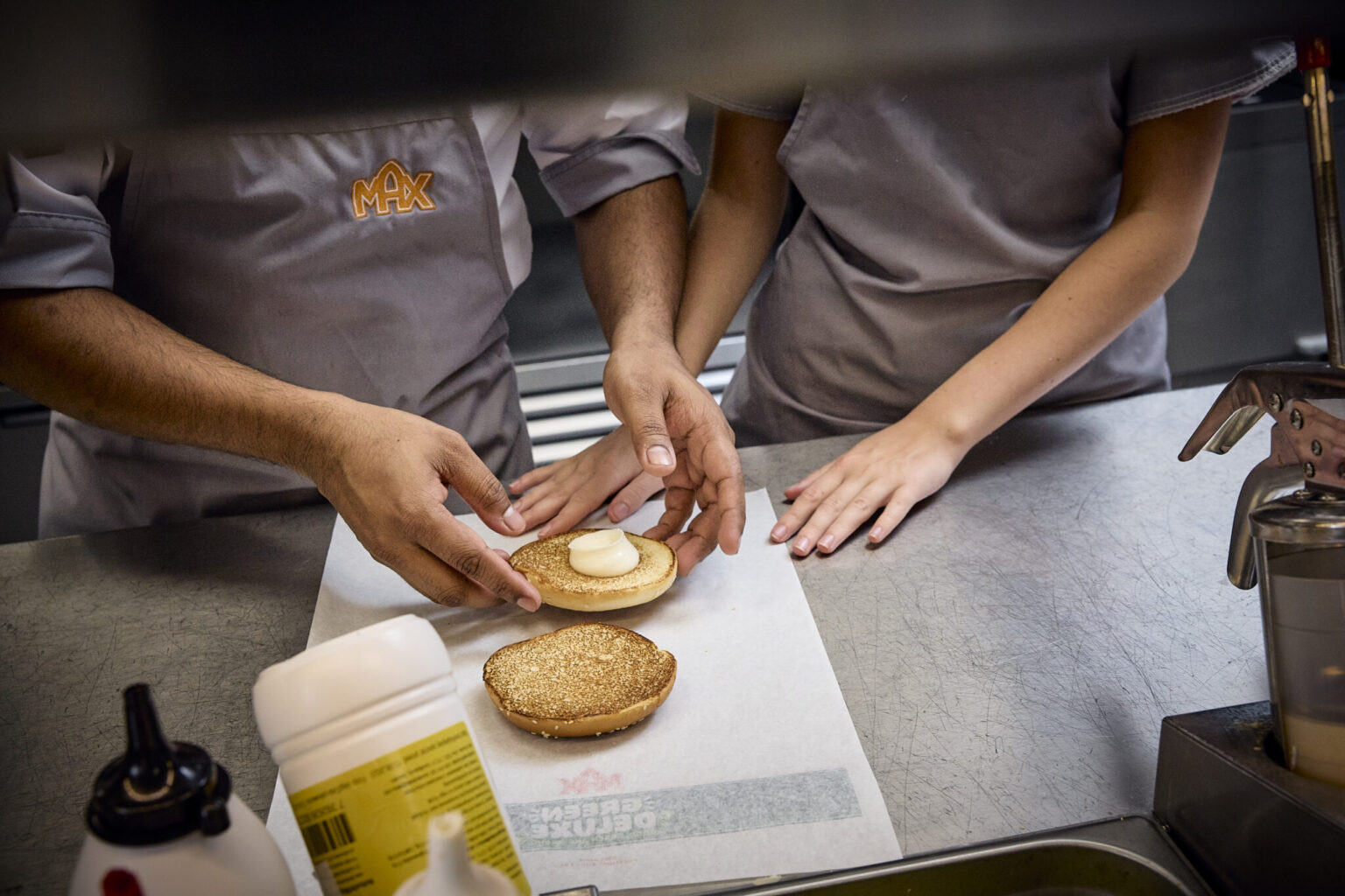 a man and woman making a sandwich