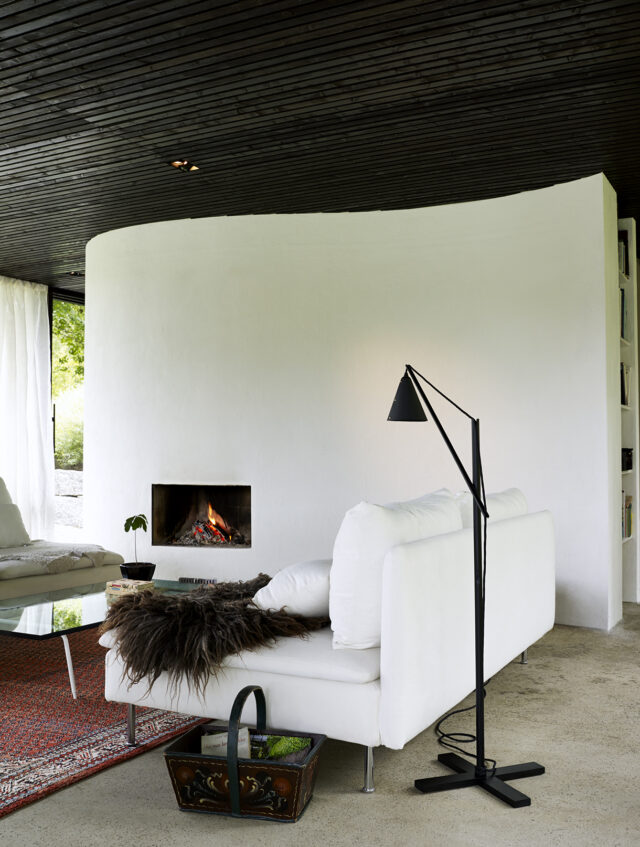 a white couch in a room with a fireplace