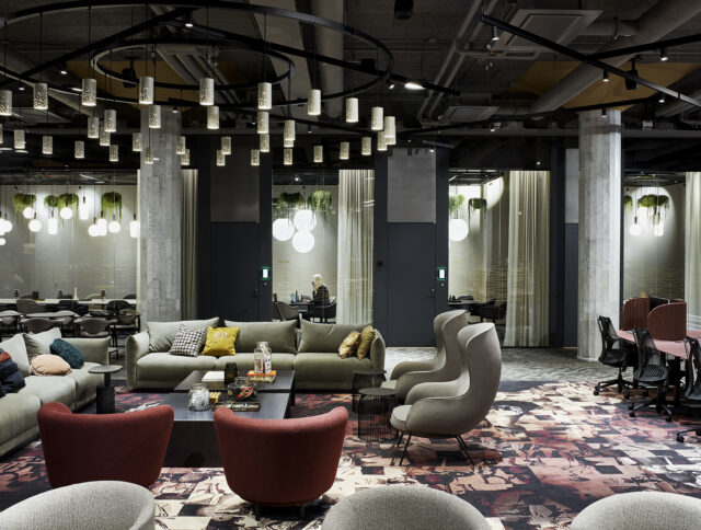 a room with a couch and chairs