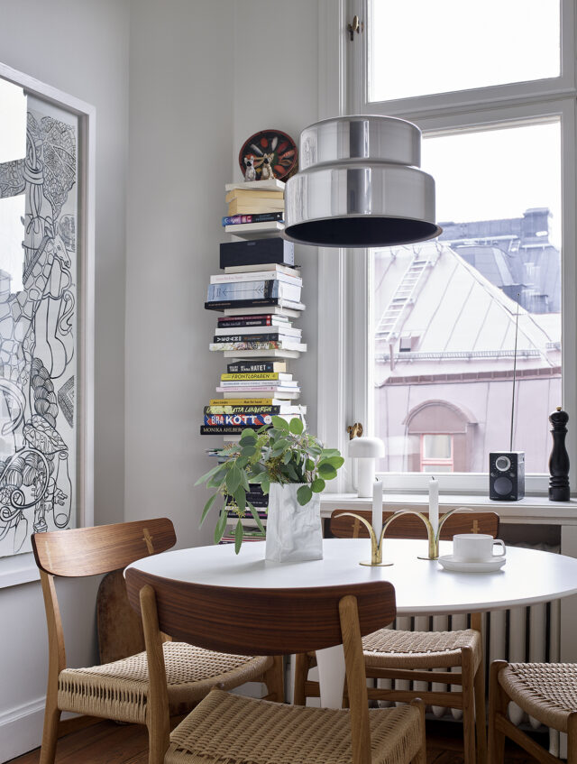 a table with chairs and a plant on it