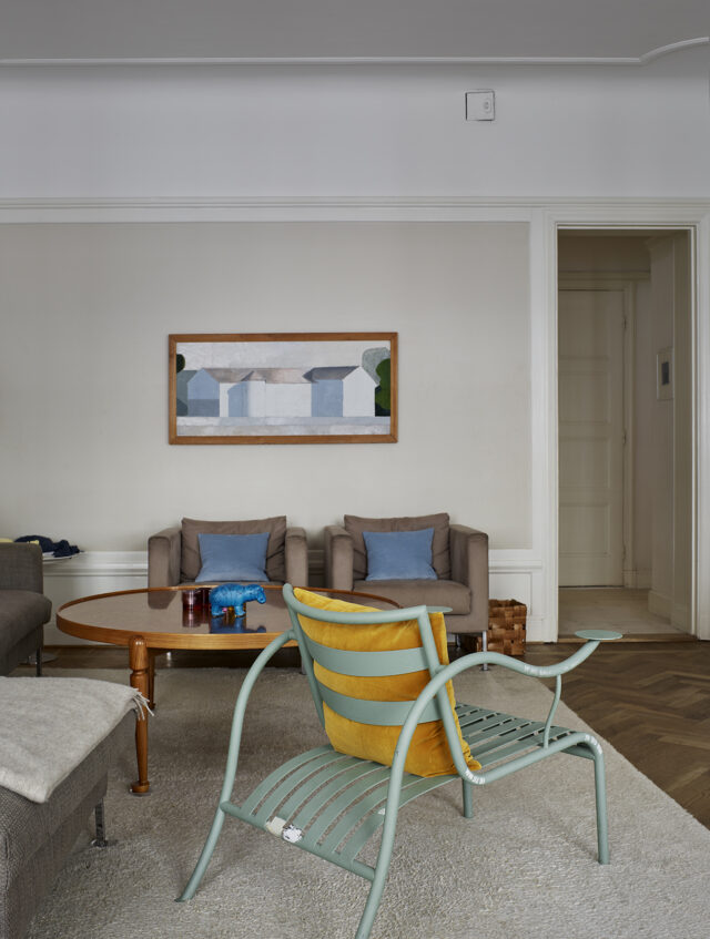 a living room with a chair and a table