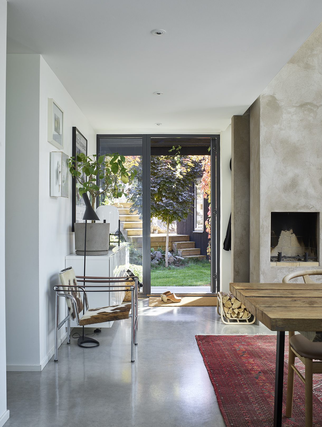 a room with a table and chairs and a fireplace
