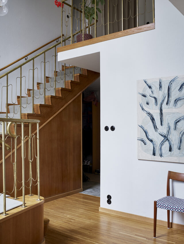 a staircase with a painting on the wall