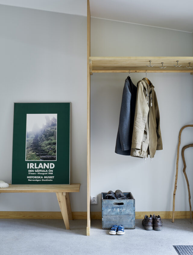 a coat rack and shoes in a room