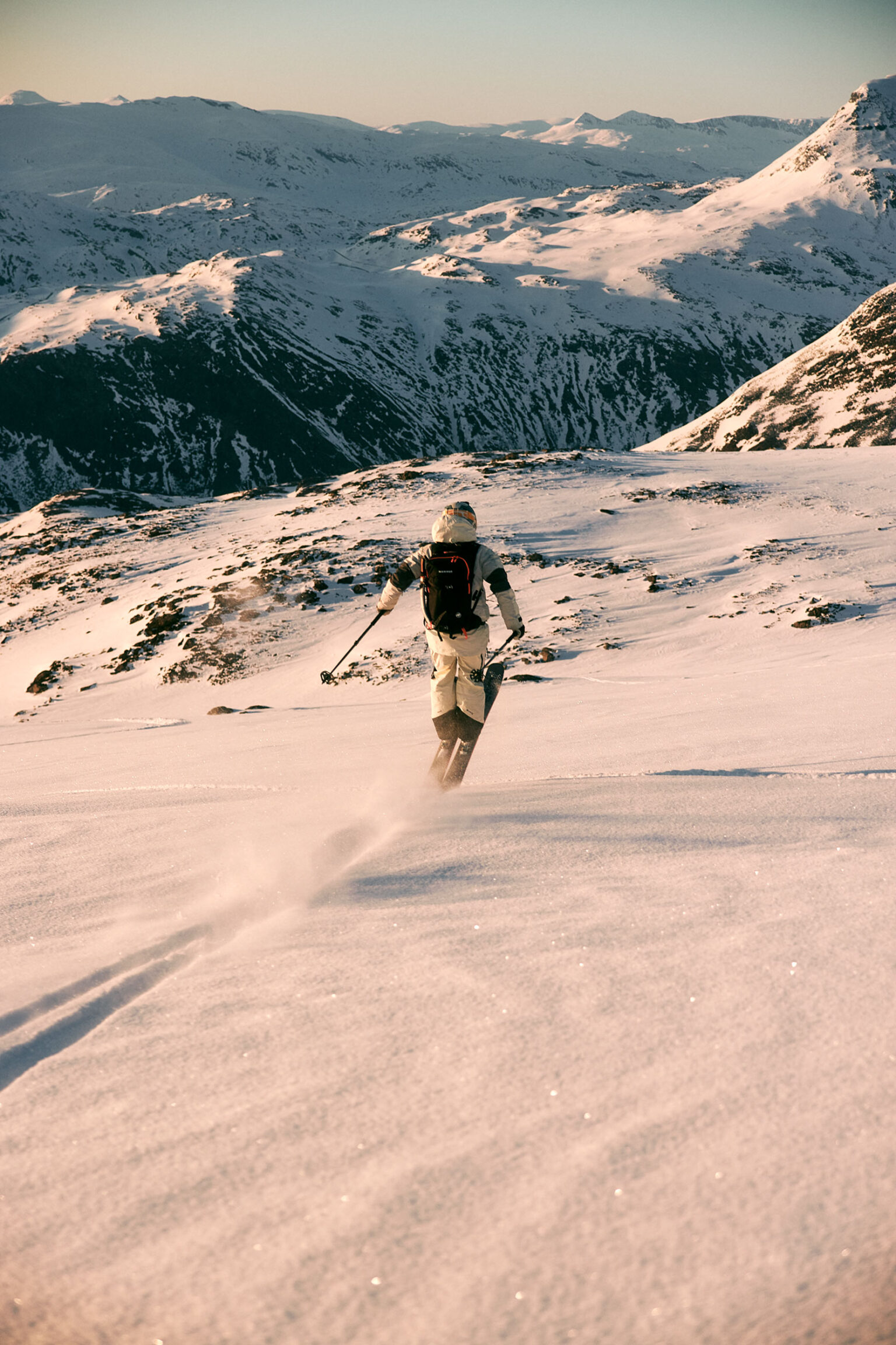 a person skiing down a snowy mountain