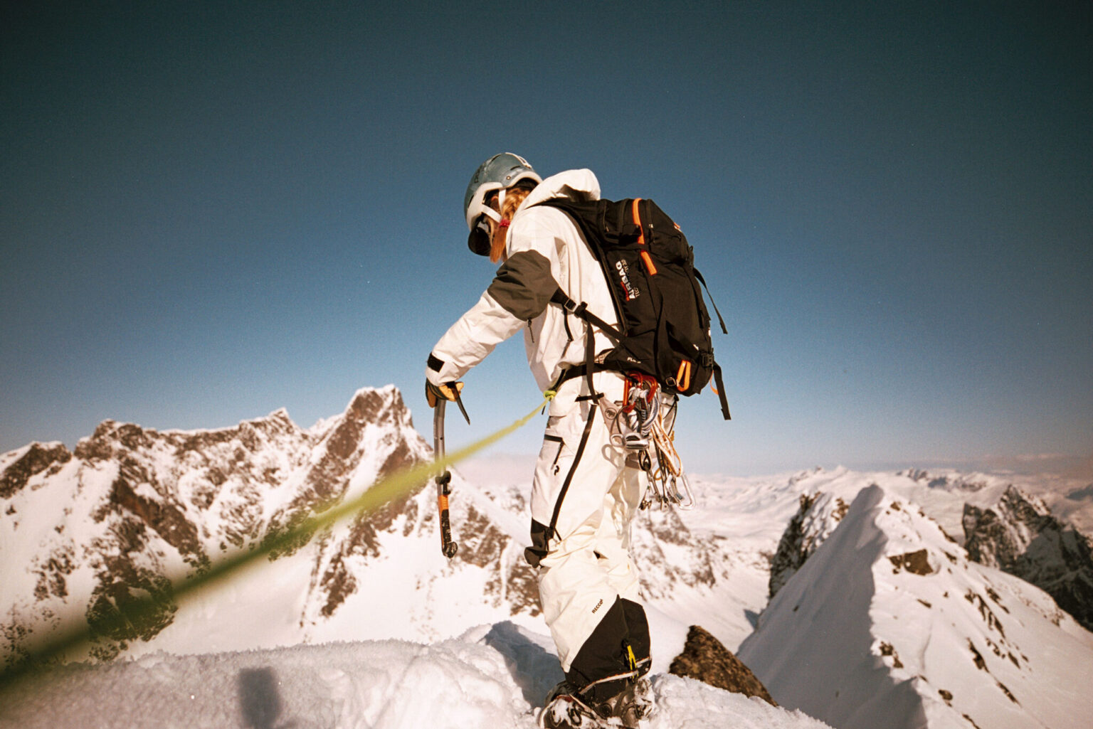 a person in a snow suit on a snowy mountain