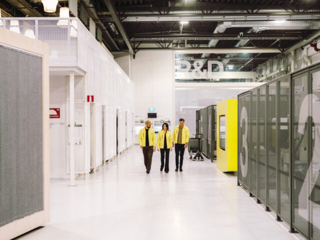 a group of people walking in a white room