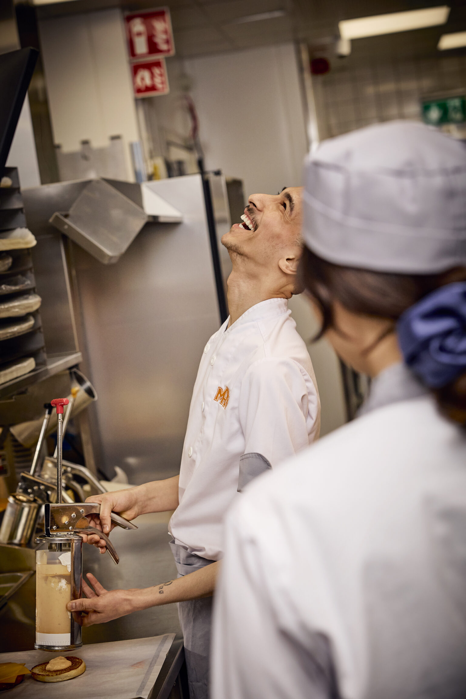 a man and woman in a kitchen