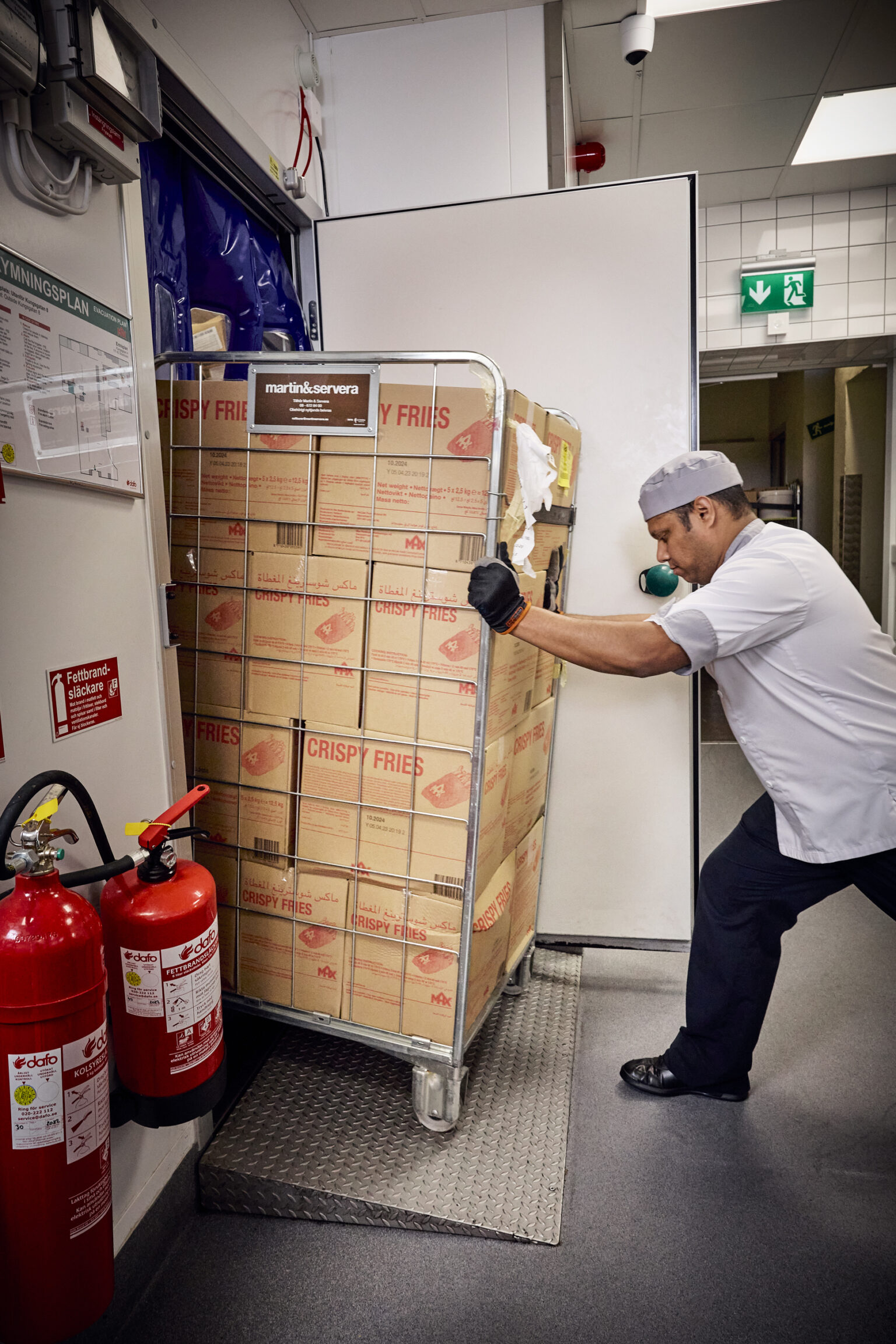 a man pushing a cart full of boxes