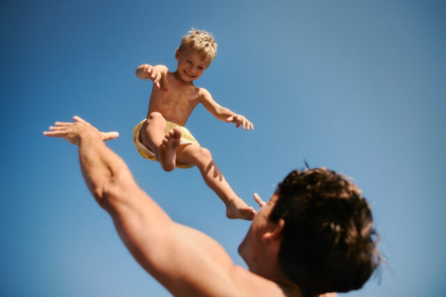 a man and child jumping in the air