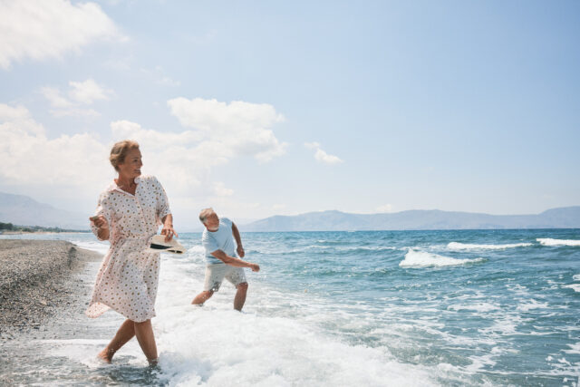 a man and woman walking in the water