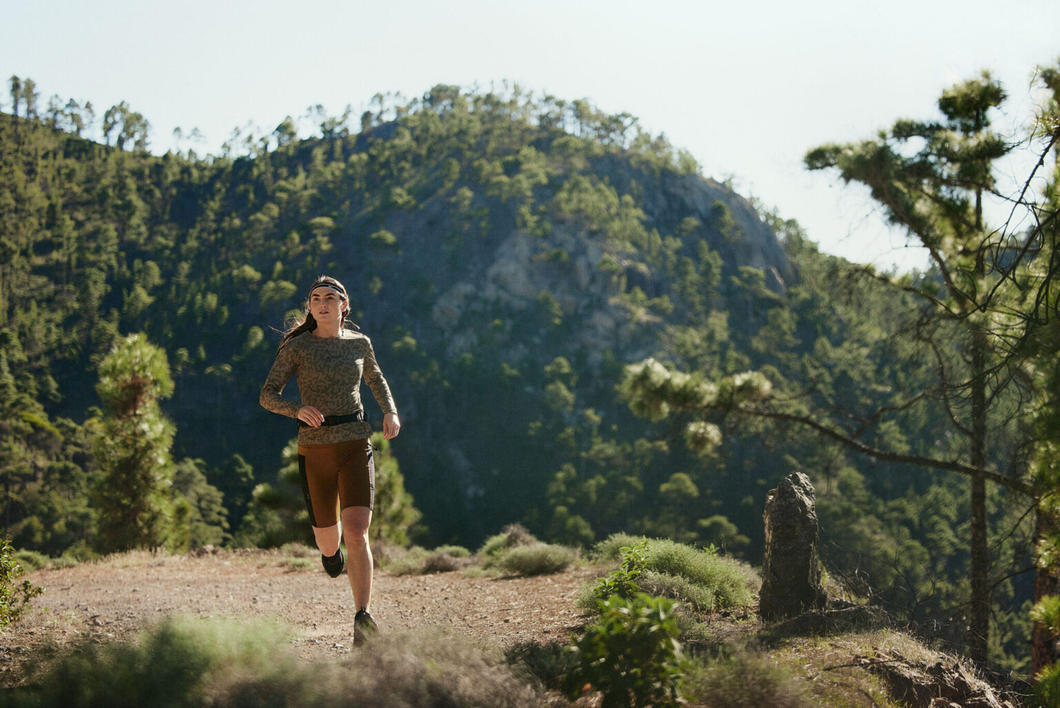 a woman running on a trail