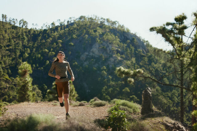 a woman running on a trail