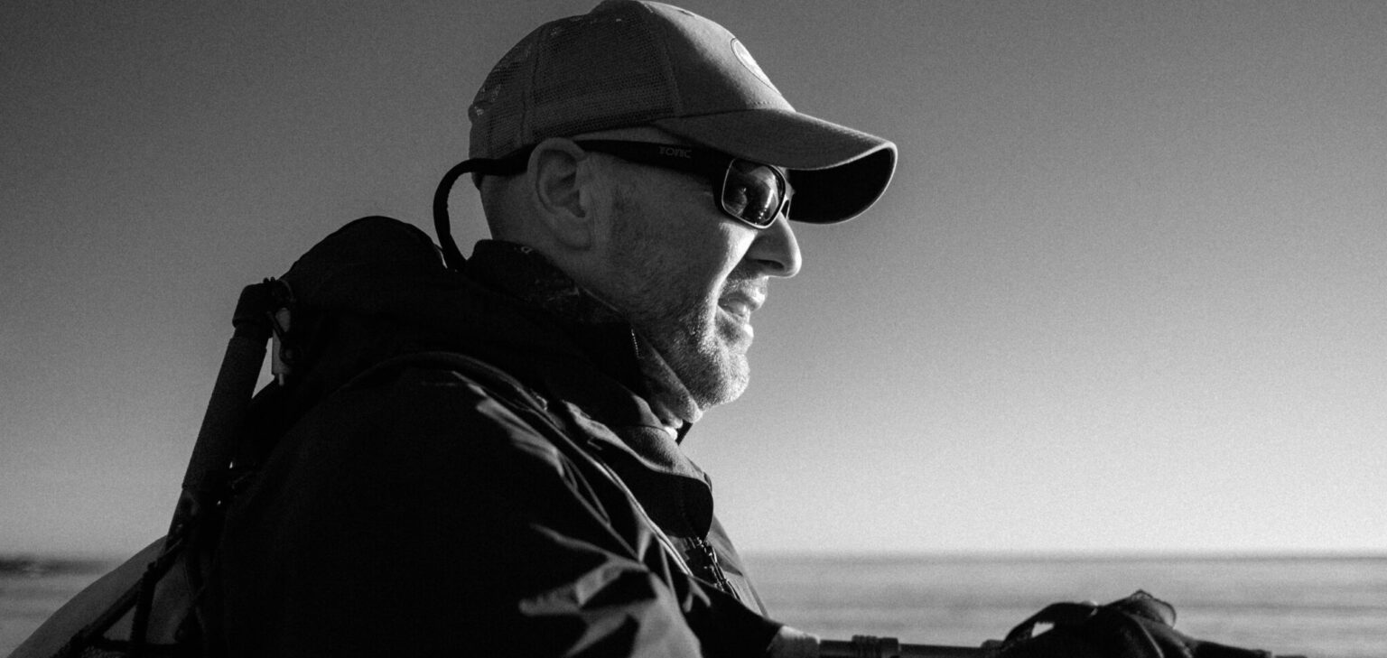 a man in a hat and sunglasses