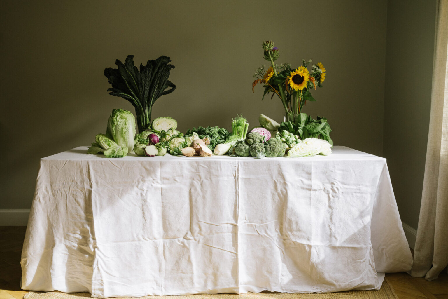 a table with vegetables and flowers on it
