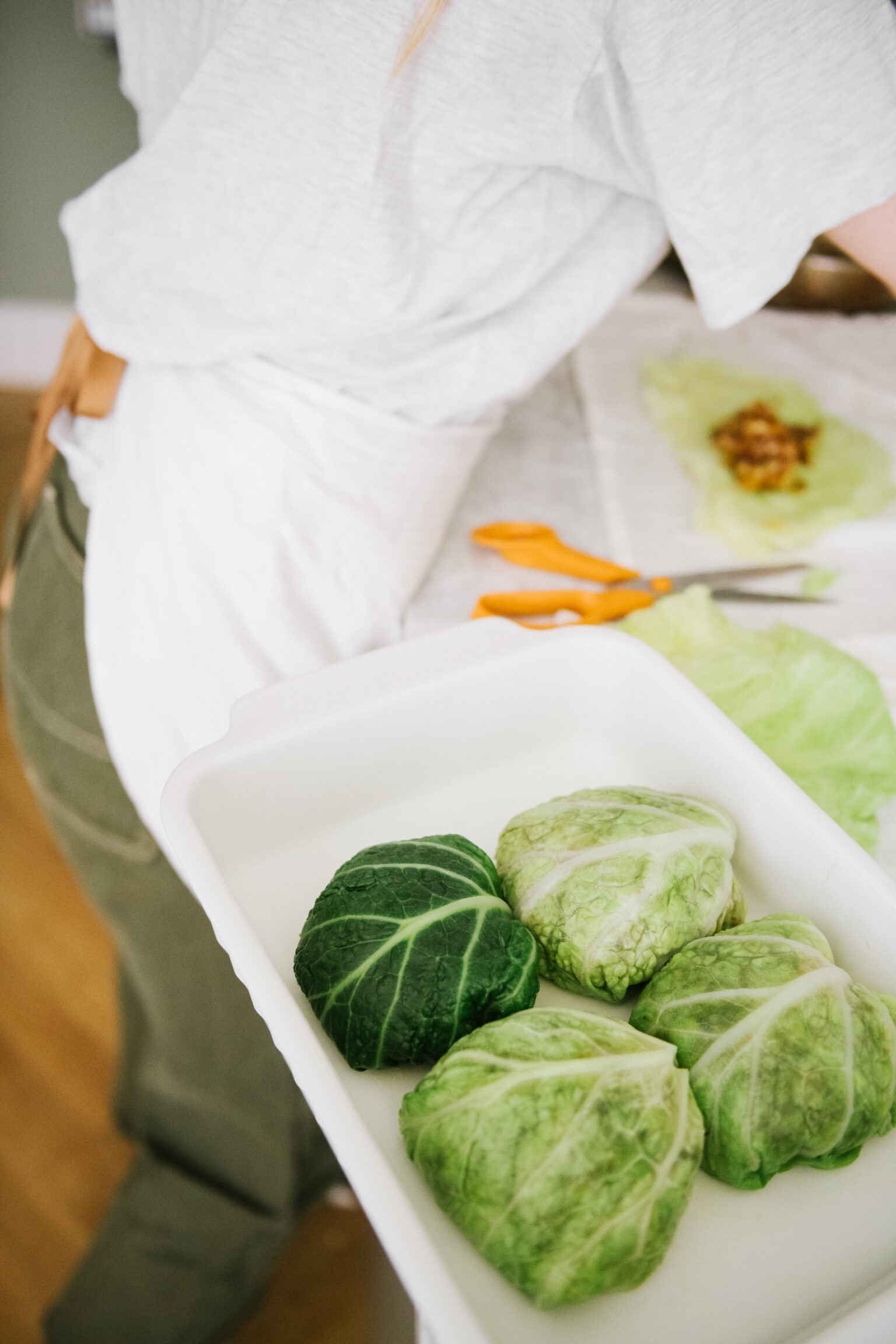 a person holding a container of cabbage