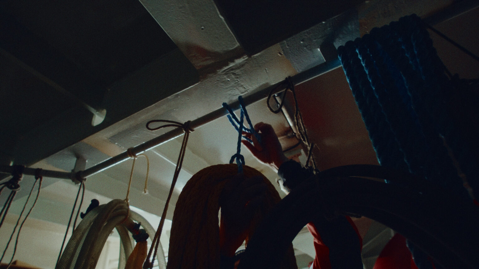 a person holding ropes and from a pipe