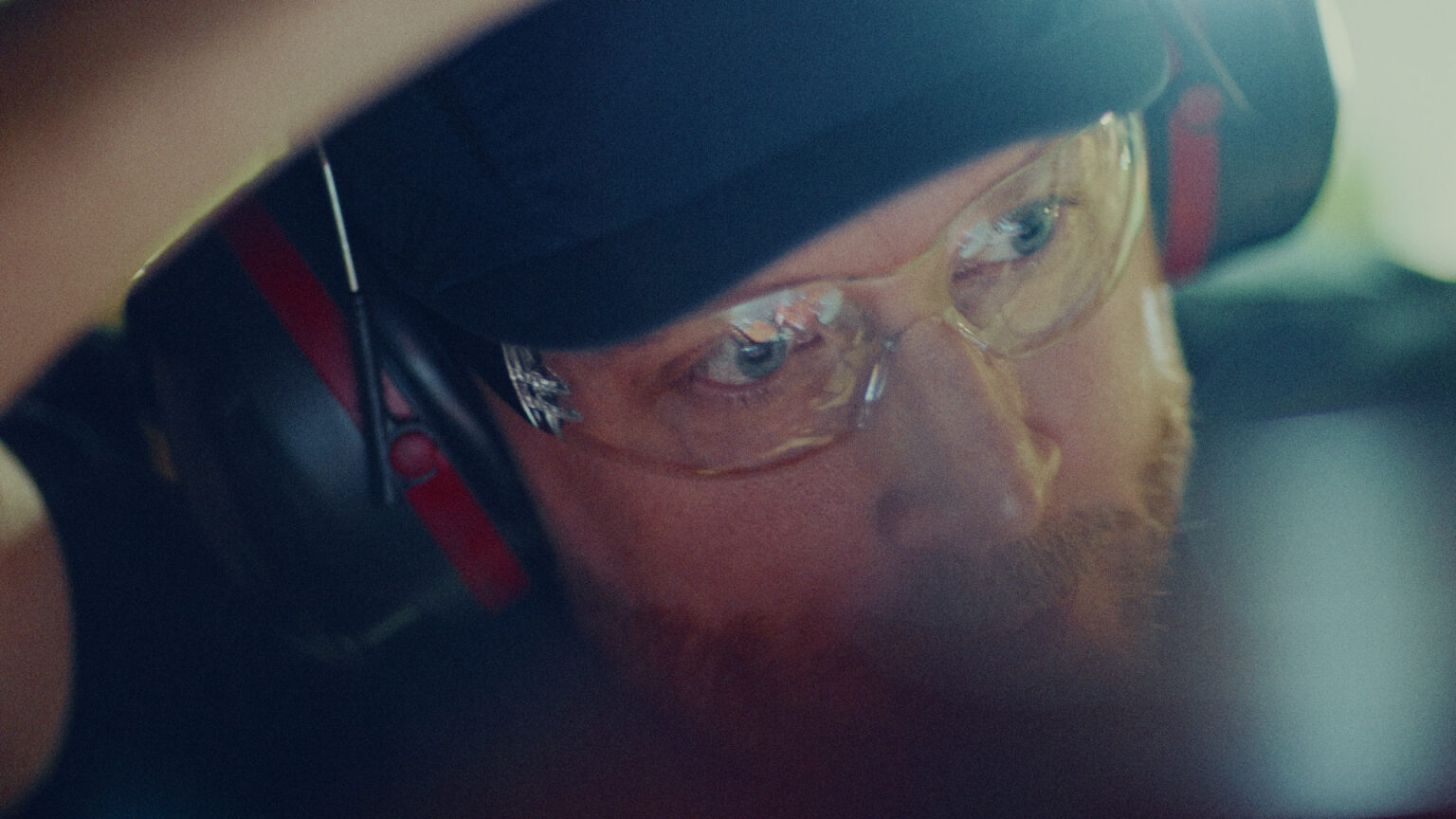 a man wearing glasses and a hat