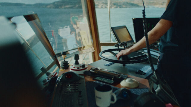 a person's hand on a steering wheel