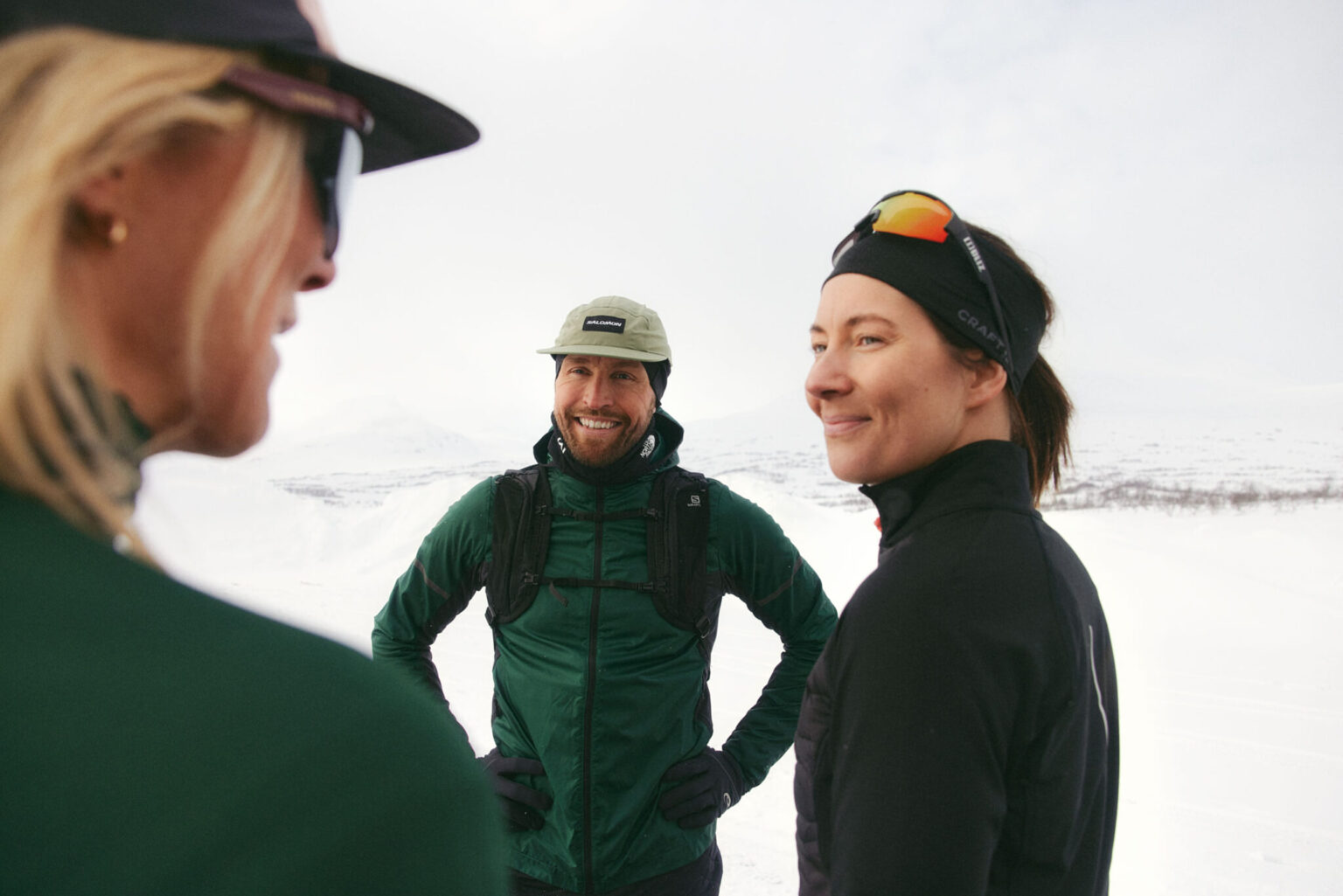 a group of people standing in the snow