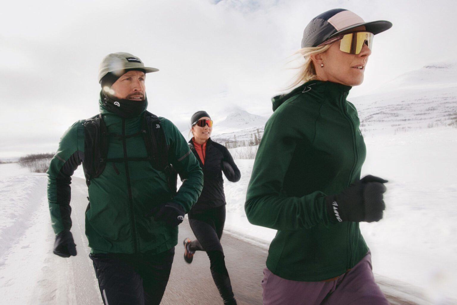 a group of people running in the snow