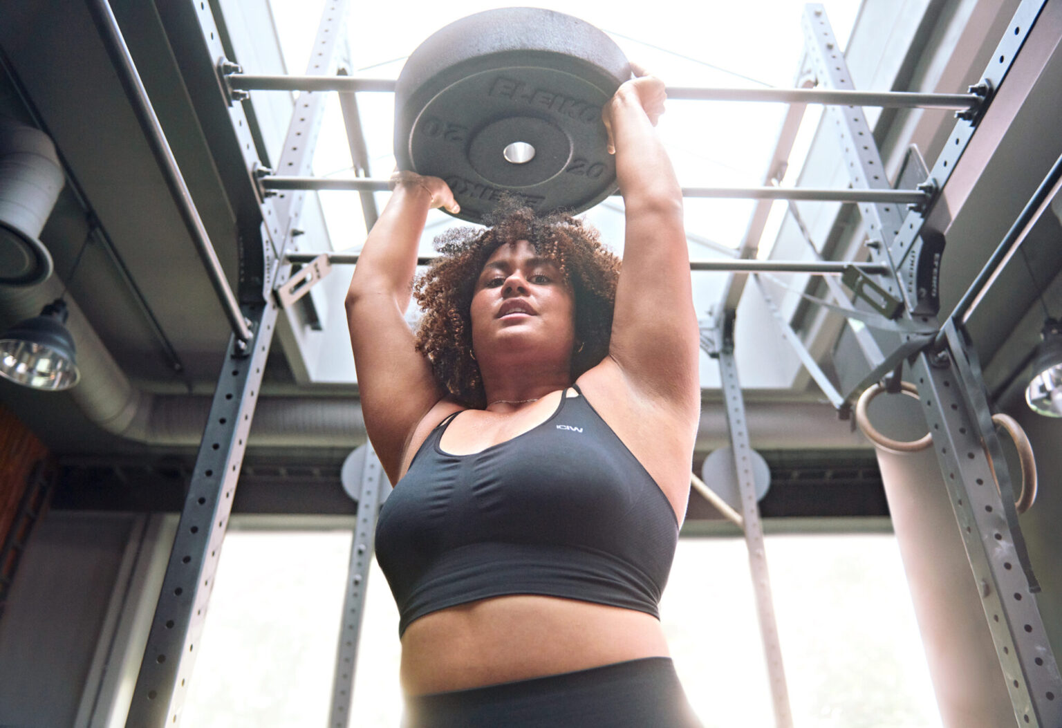 a woman lifting weights over her head