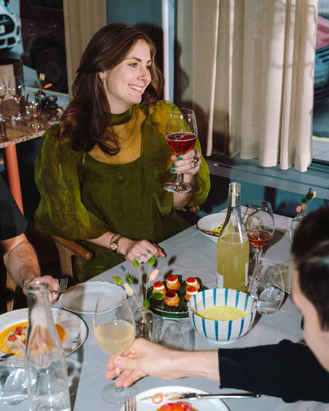 a woman holding a glass of wine
