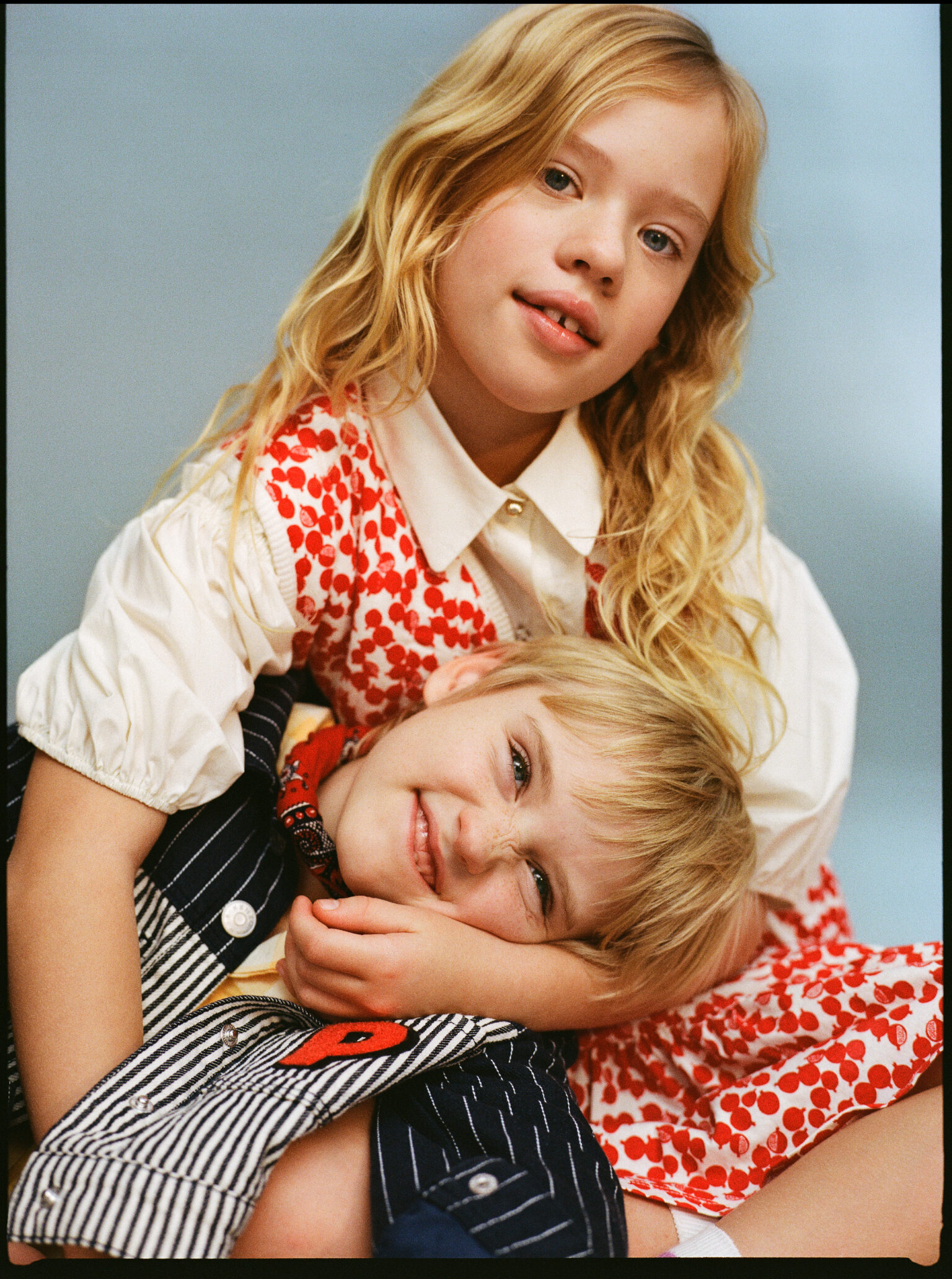 a girl holding a boy