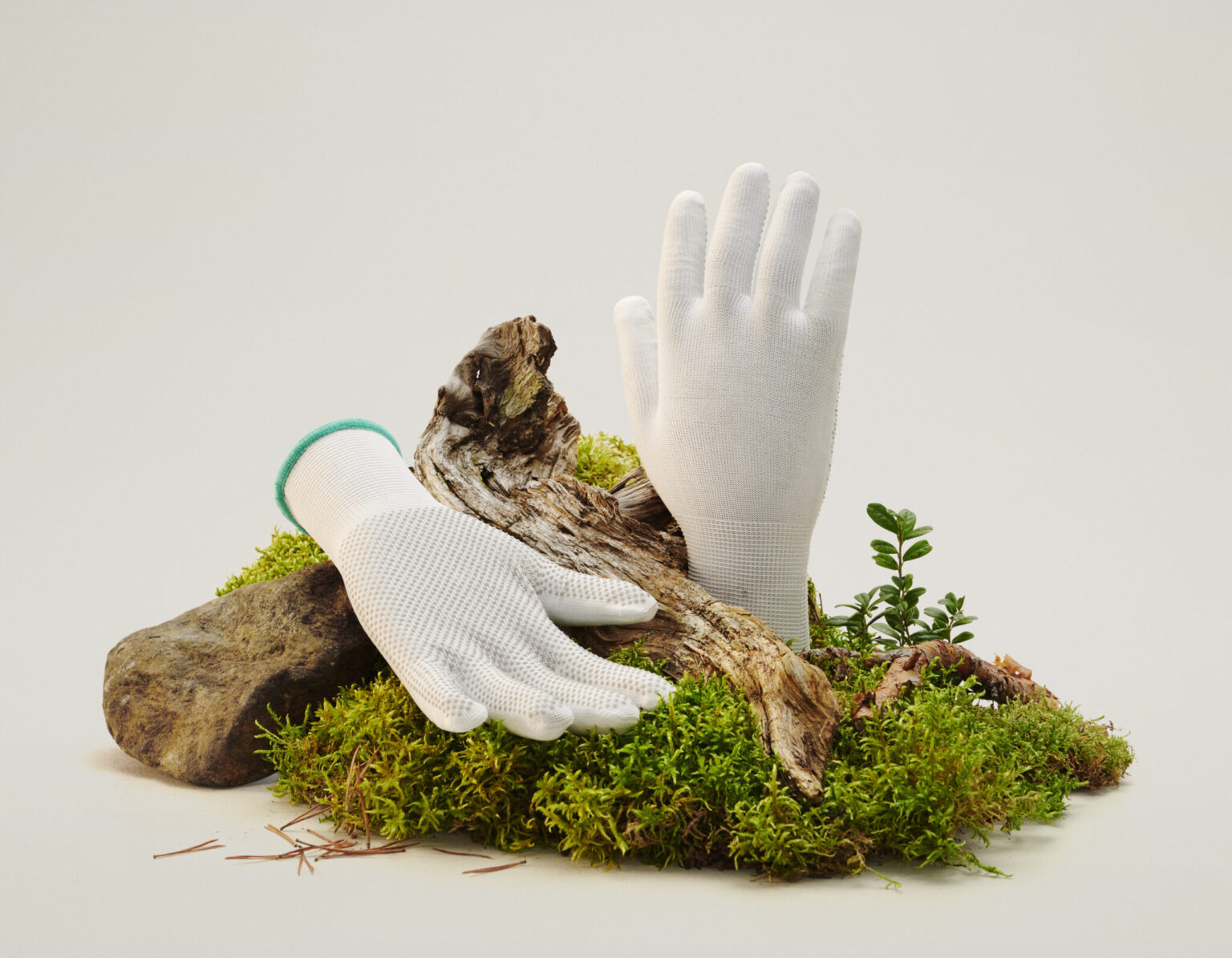 a pair of gloves on a mossy surface