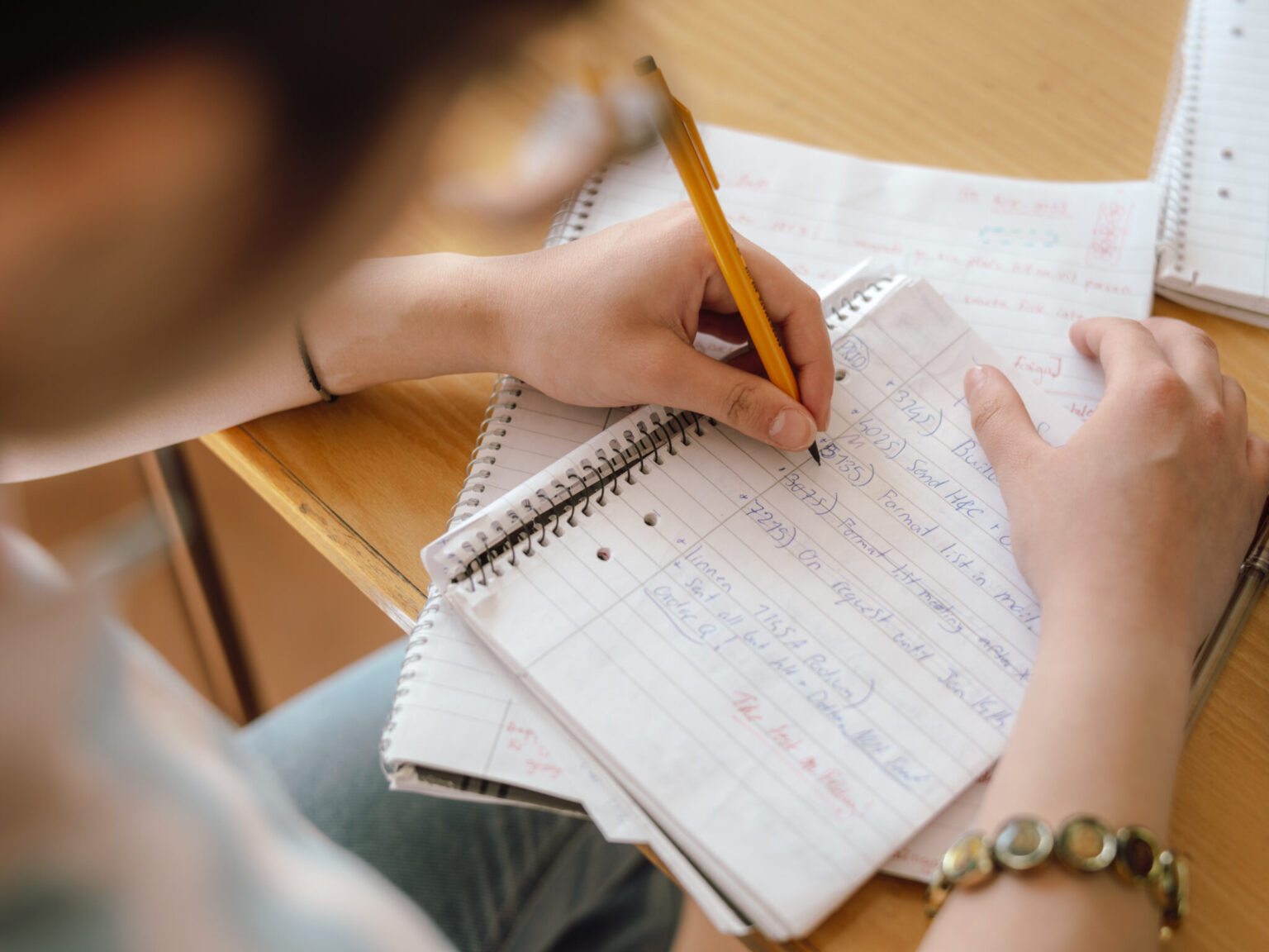 a person writing in a notebook