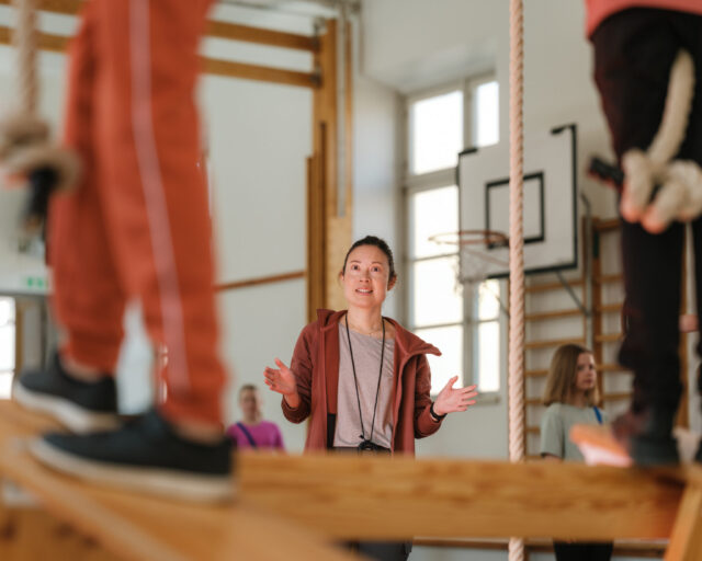 a woman standing on a beam