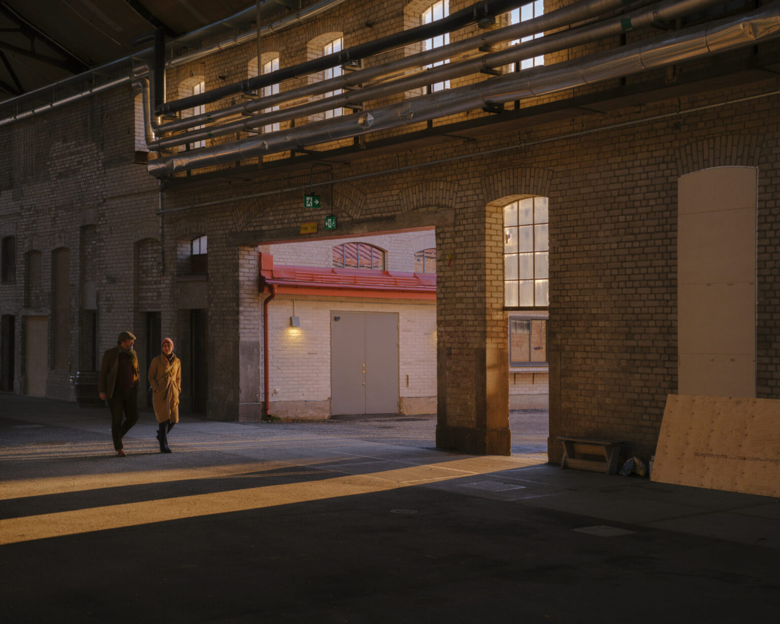 a couple of people walking in a building