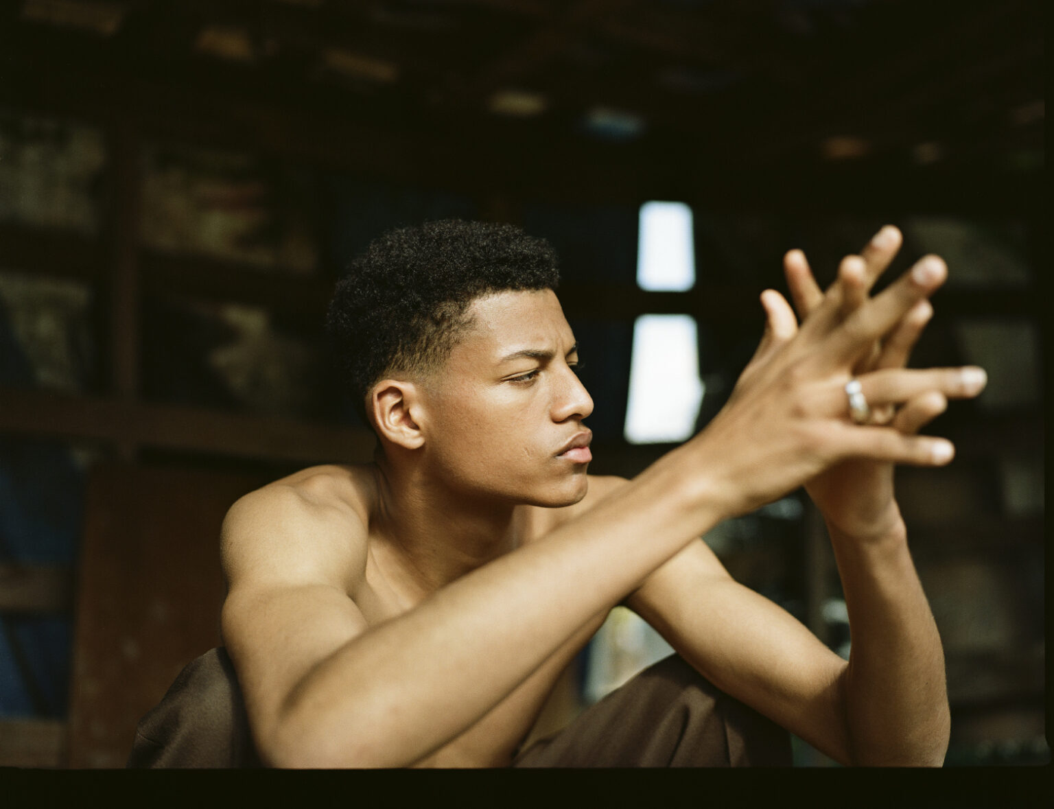 a man sitting with his hands in the air