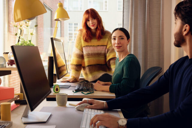 a group of people sitting at a desk